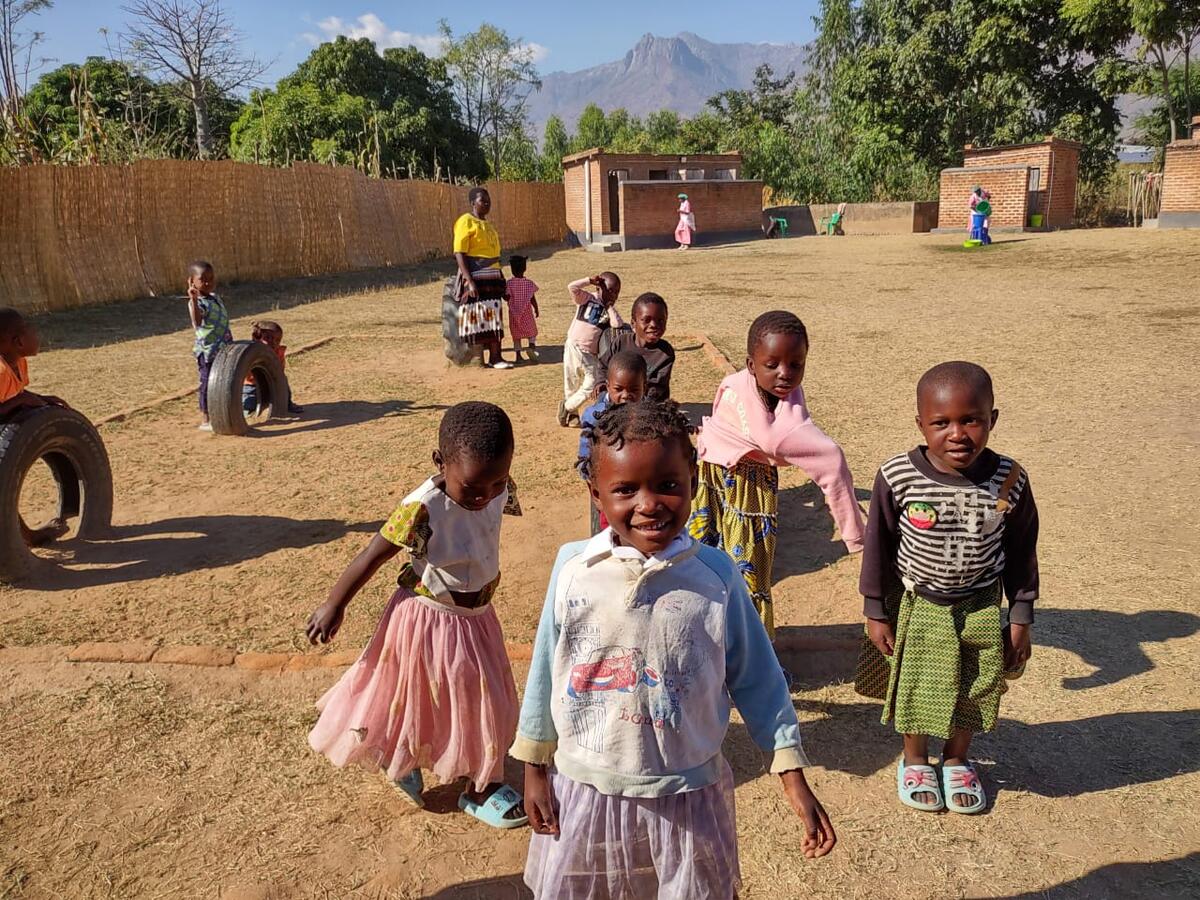 Children playing on tire swings on the playground